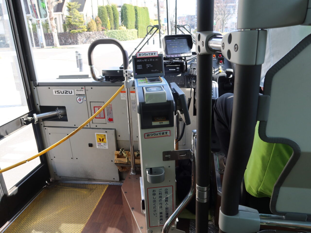 Fare box and payment equipment beside the driver on a Japanese local bus