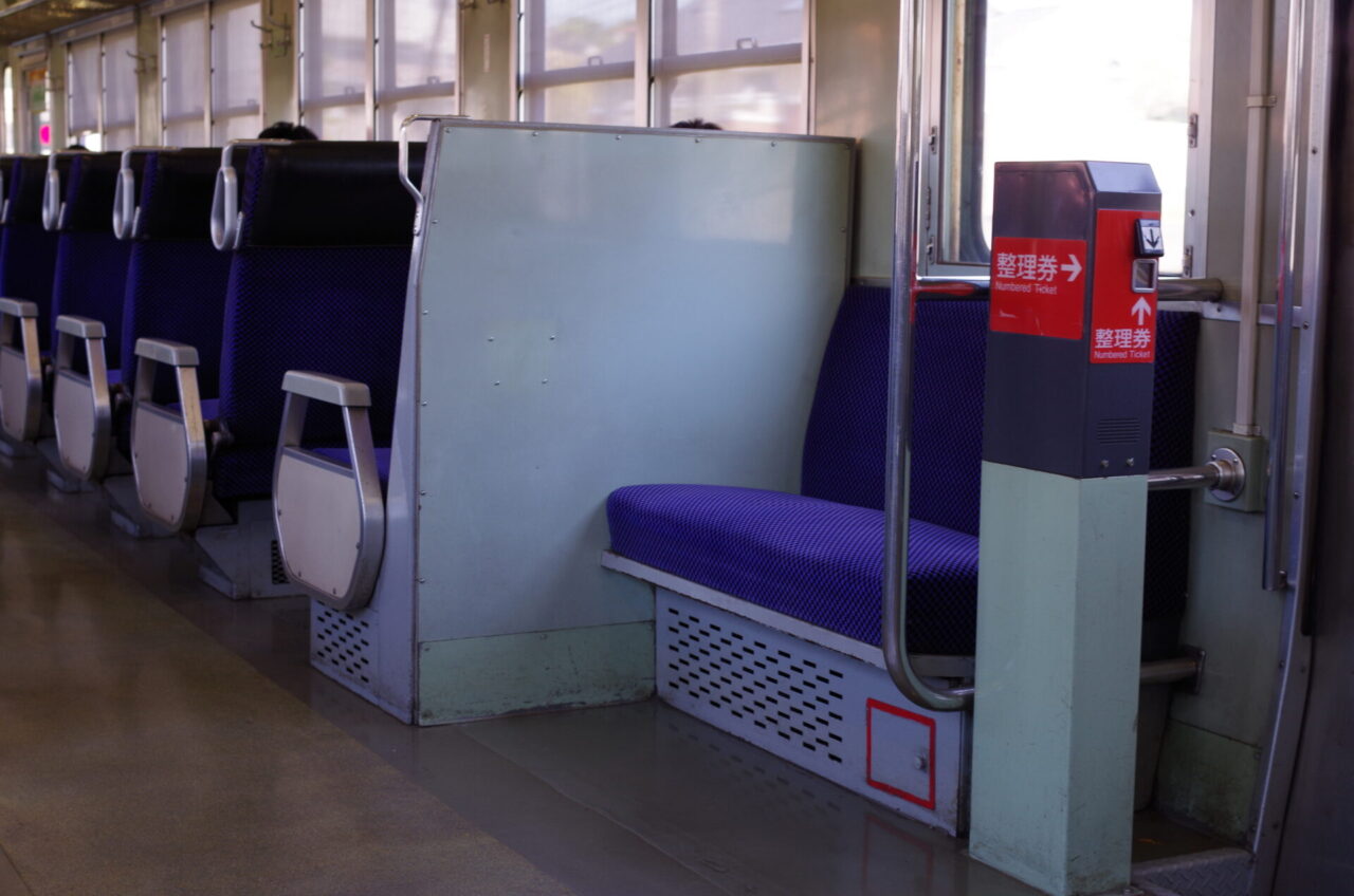 Numbered ticket machine inside a one-man-operated local train in Japan