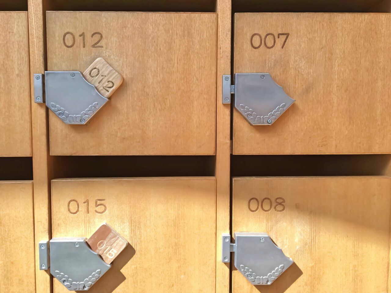 Wooden shoe lockers with numbered keys at a Japanese public bath